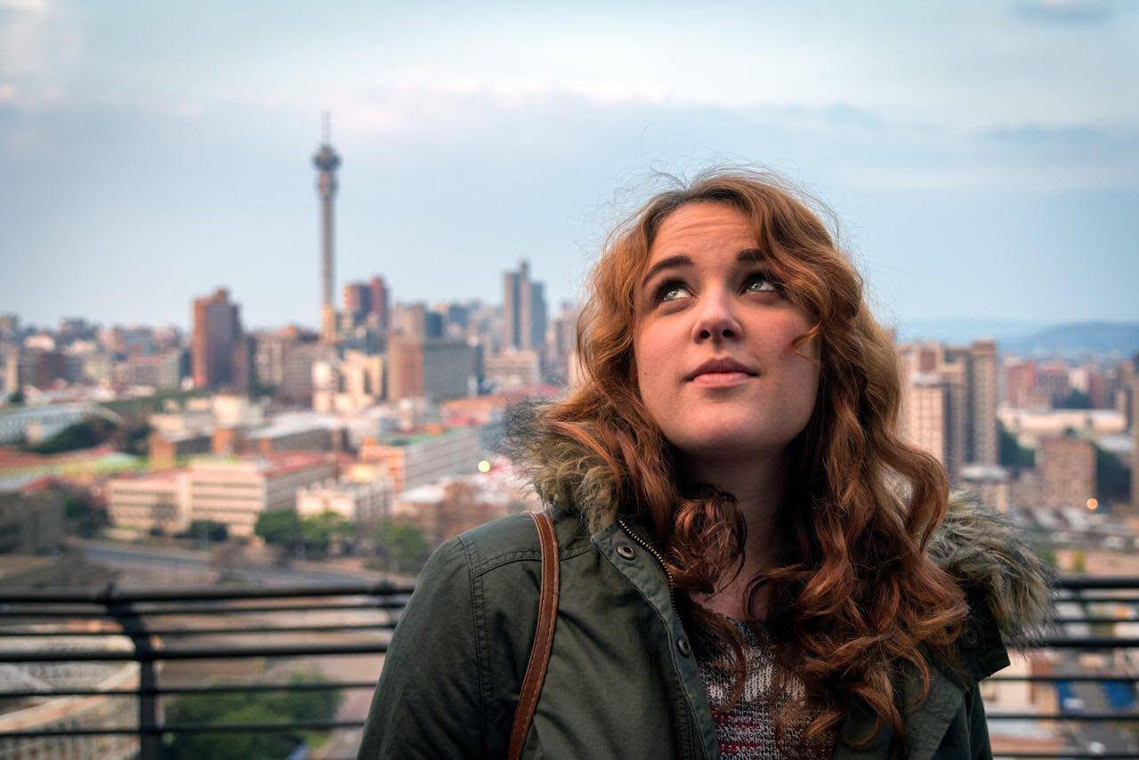 Photo of Lauren Rawlins in front of Johannesburg skyline